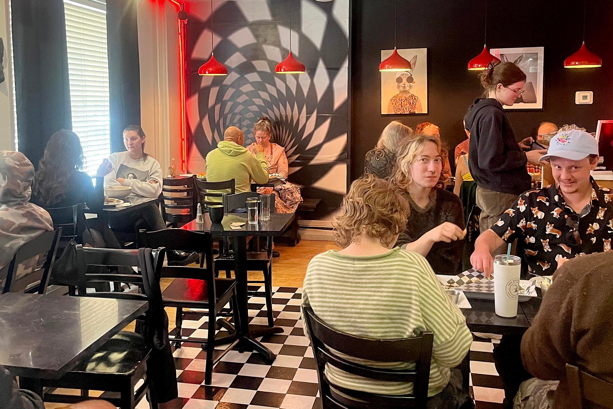 people eating vegan food in a checkered cafe people eating vegan food in a checkered cafe