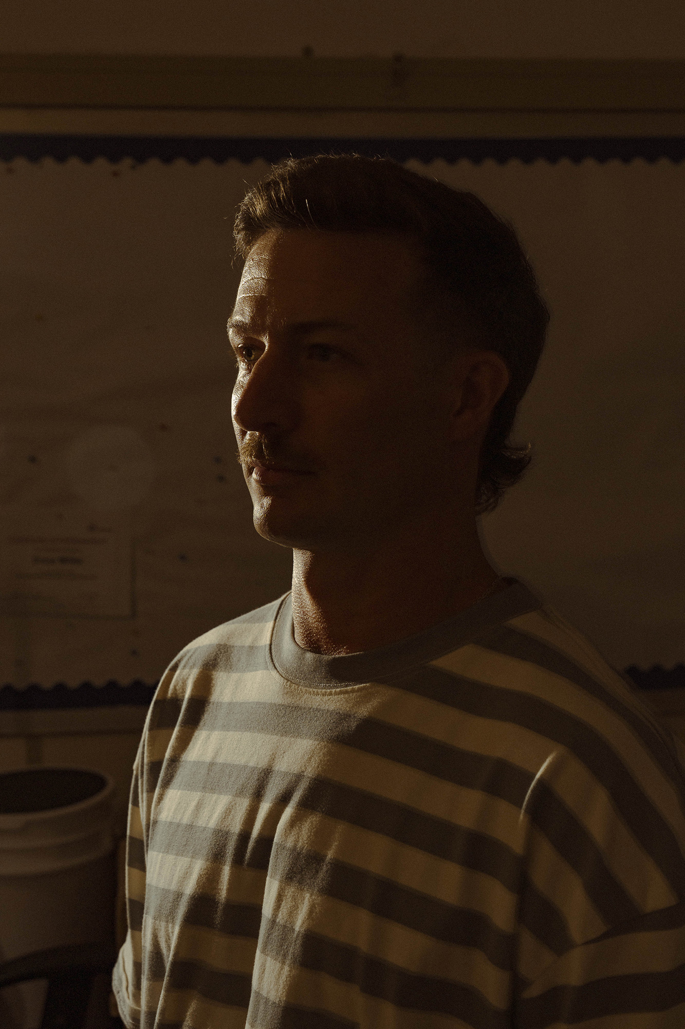Portrait of man in a dark shadow.