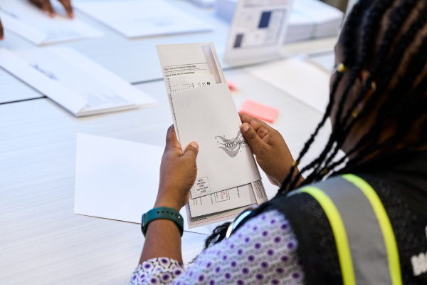 A Wake County Board of Elections employee prepares a mail-in ballot to be sent out to a voter in September in Raleigh, N.C.